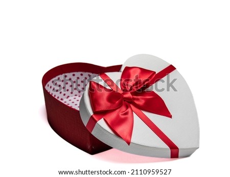 A single heart shaped gift box on a white background with copy space
