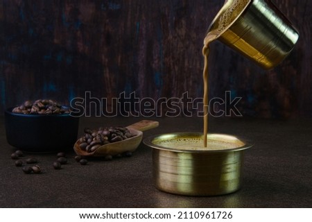 Filter coffee served in a brass cup Royalty-Free Stock Photo #2110961726