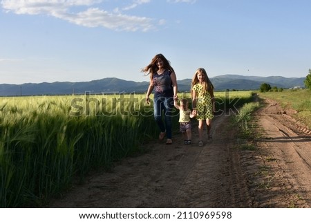 family on the background of a field of wheat,