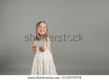 the girl holds a bank business card in her outstretched hands, place your own text on it.