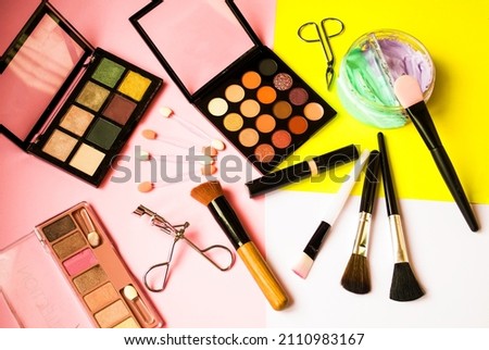 Decorative cosmetics and face makeup accessories, on a colored background.  The concept of beauty and healthy complexion.  Banner, photo top view, close-up, background picture