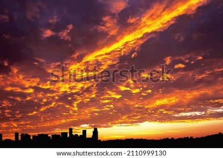 A vibrant sunset behind the city skyline in Toronto, Ontario, Canada.