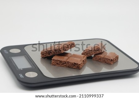 porous pieces of chocolate on a white background. Healthy food. The concept of a healthy lifestyle. Weight control .