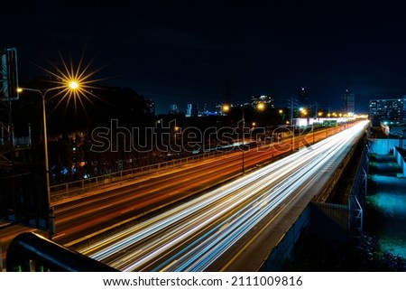 light trails on toll way middle of city