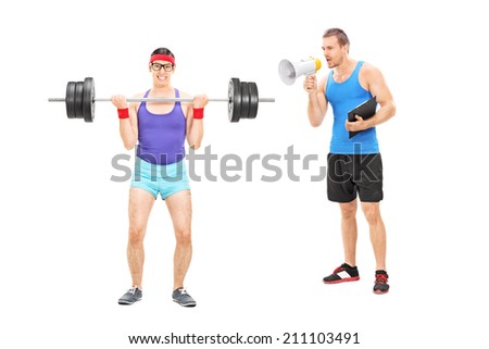 Fitness coach shouting at a nerdy guy through megaphone isolated on white background