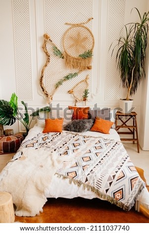 bedroom decor in eco style. bed with a dreamcatch on the wall. bed linen and decor. shop of accessories and household goods.