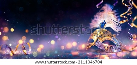 Carnival Party - Venetian Mask With Abstract Defocused Bokeh Lights And Shiny Streamers - Masquerade Disguise Concept Royalty-Free Stock Photo #2111046704