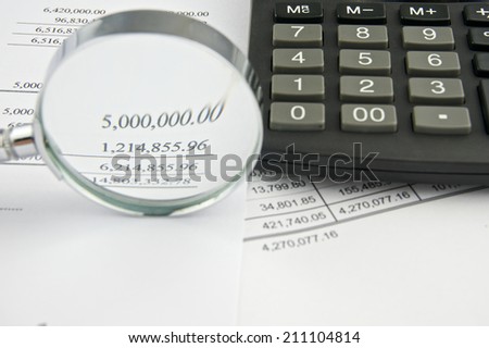 Document of account include balance sheet and sales with magnifier and black calculator. Business and finance concepts rich and successful photography.