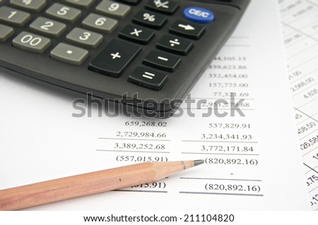 Statements of income include sales with pencil and black calculator. Business and finance concepts rich and successful photography.