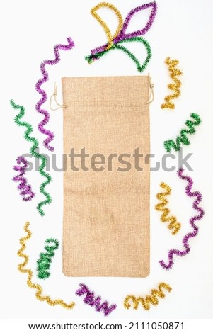 Mardi Gras Vertical Mockup. Empty blank wine gift bag on white table. Mardi Gras party Mock up