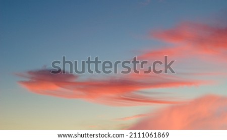 Red colored clouds in the sky, sunset in the form of motion