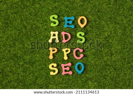 Colorful alphabet or letters for seo website concept on green grass background. Our business.