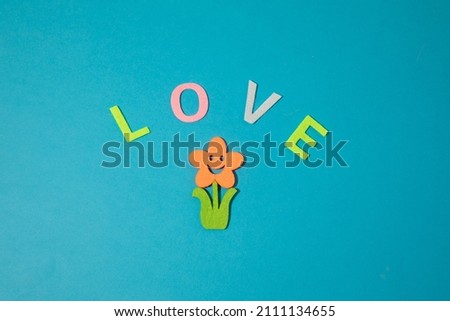 Valentine's day concept with letters love and wooden heart. Decor in shape of word LOVE. white letters. Valentine concept. Color of the year 2022. Very peri tint. Selective focus.