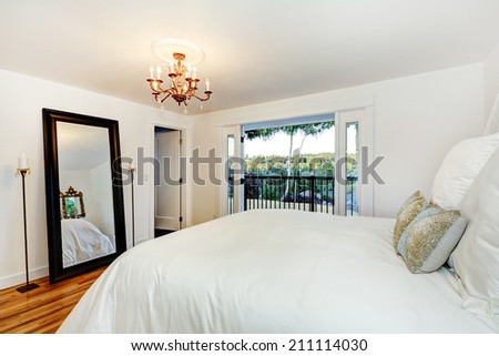 Refreshing white bedroom with beautiful bed and walkout deck