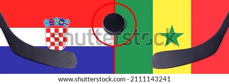 Top view hockey puck with Croatia vs. Senegal command with the sticks on the flag. Concept hockey competitions