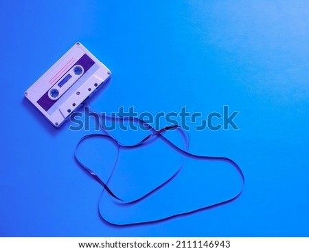 Retro with an audio cassette unwound on a blue background. Organization of a musical party. Vintage, retro design. poster design.