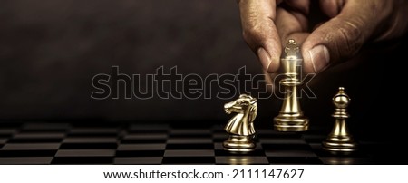 Hand choose king chess standing with teamwork on chess board concept of team player or business team and leadership strategy and human resources organization management.
