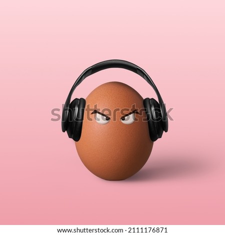Angry egg with headphones on pink background.