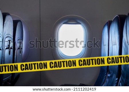 Empty interior of an airplane and yellow tape means do not  sitting here, concept picture about virus pandemic in the World