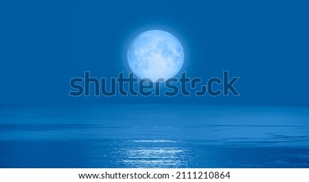 Night sky with blue moon in the clouds "Elements of this image furnished by NASA"