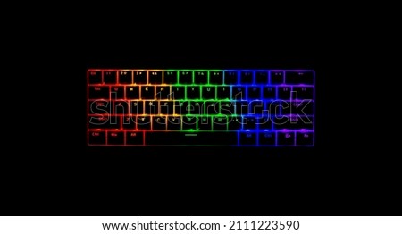 Mechanical gaming keyboard lit up with RGB LED lights. 65% size keyboard. Colors include red, green and blue. Isolated on its own, as a product photo. Plain black background. Copy space to add text. Royalty-Free Stock Photo #2111223590