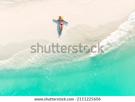 Top view of woman in red bikini sunbathing in the  summer tropical on the beach trip concept