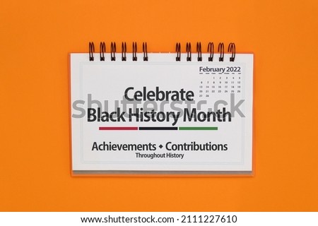 Close up of Celebrate Black History Month sign on orange background Royalty-Free Stock Photo #2111227610