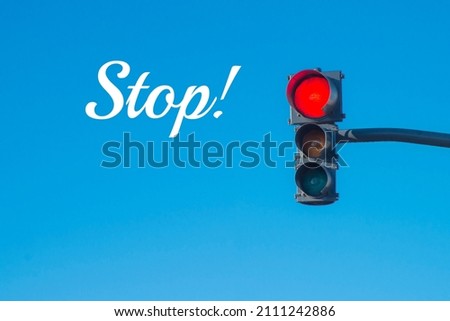 Traffic light in red with blue sky