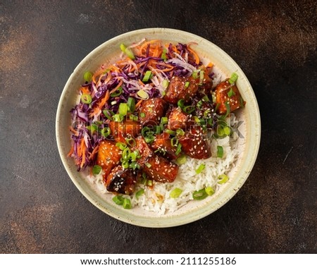 Vegan fried tempeh with rice and vegetables. Asian healthy food Royalty-Free Stock Photo #2111255186