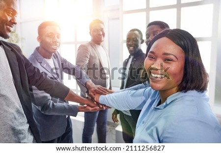 young business woman and her colleagues are showing their unity . Royalty-Free Stock Photo #2111256827