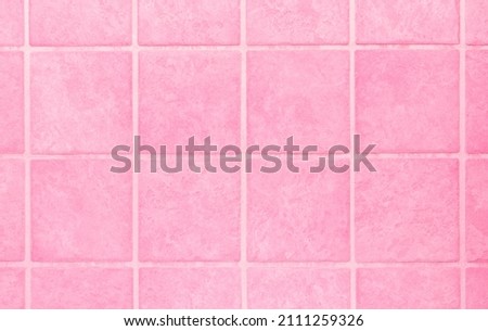 Square pink tile wall background.