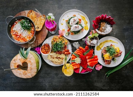 Food and drink shot of several different healthy meals using tropical fruits and Indonesian inspired dishes Royalty-Free Stock Photo #2111262584