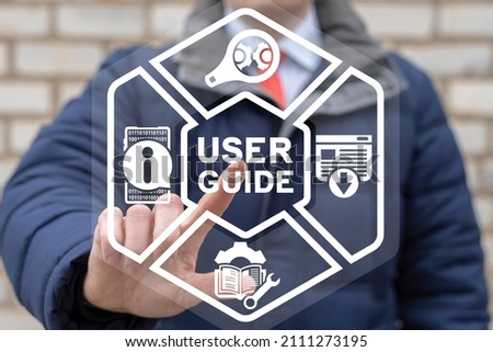 Man using virtual touch screen clicks a user guide inscription. User Manual Guide Business Service Communication Internet Technology Concept. Royalty-Free Stock Photo #2111273195