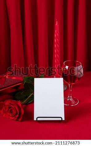 Valentine's Day blank message card with red rose and red gift box. Romantic love message. Valentine Gift With Wine And Roses