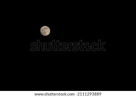Moon on a black background. Night photo.