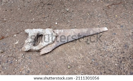 brown old weathered and rusty wood saw