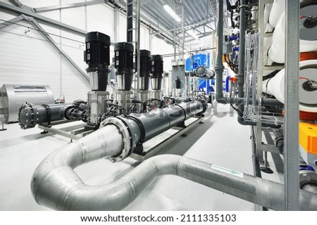 Pump station for reverse osmosis industrial city water treatment station. Wide angle perspective. Technology, chemistry, heating, work safety, supply, infrastructure Royalty-Free Stock Photo #2111335103