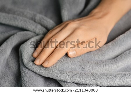 Grey blanket texture. Wave material pattern. Gentle and fluffy blanket. Woman touching grey blanket Royalty-Free Stock Photo #2111348888