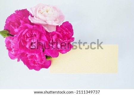 Mockup of Mother's Day greeting card with red and pink carnation flowers