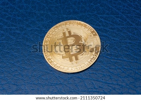 Cryptocurrency gold bitcoin coin on blue background, electronic virtual money for web banking and international network payment