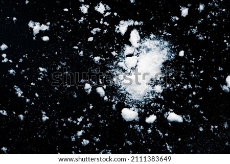 Snow wrecks, scattered on black background.