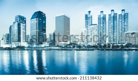 Bangkok city reflect in river, blue color tone.