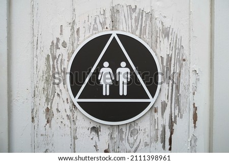 Iconic symbols on a restroom door. 