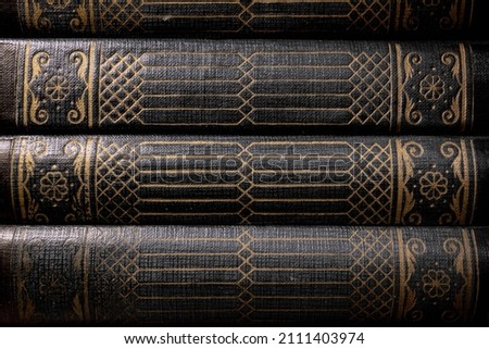 A stack of old books in hard leather binding Royalty-Free Stock Photo #2111403974