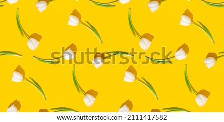 Tulips pattern. Tulips on the yellow background. Spring floral background.