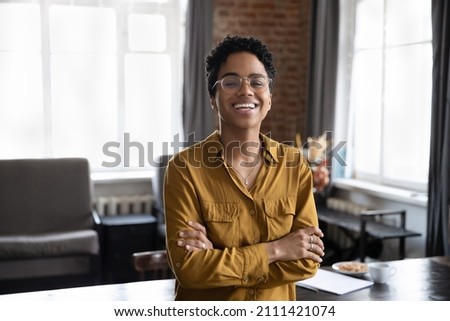 Happy cheerful young African business woman, entrepreneur, professional head shot portrait. Millennial short haired female leader, manager, employee profile picture. Corporate worker looking at camera