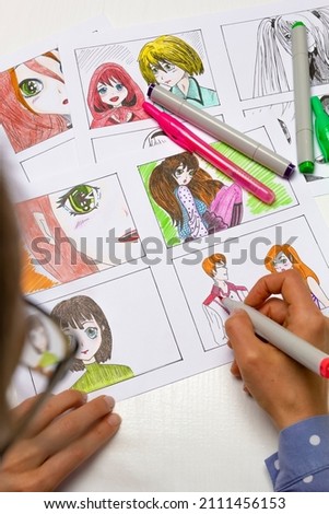 An artist draws a storyboard of an anime comics book. Manga style. The designer animator draws with a watercolor brush with a pen the characters of a color sketch of the cartoon.