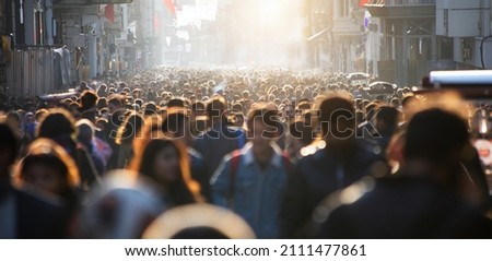 Blurred crowd of unrecognizable at the street Royalty-Free Stock Photo #2111477861