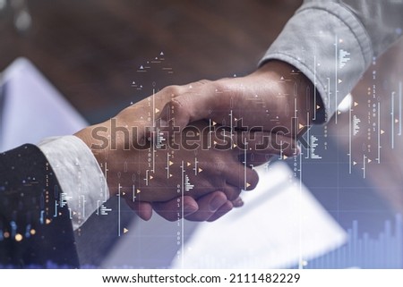 A handshake as a symbol of successful transaction on brokerage services at international investment bank. Capital market, stock trading. Financial hologram chart. Women in business. Royalty-Free Stock Photo #2111482229