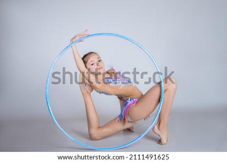 Girl gymnast with a hoop.
